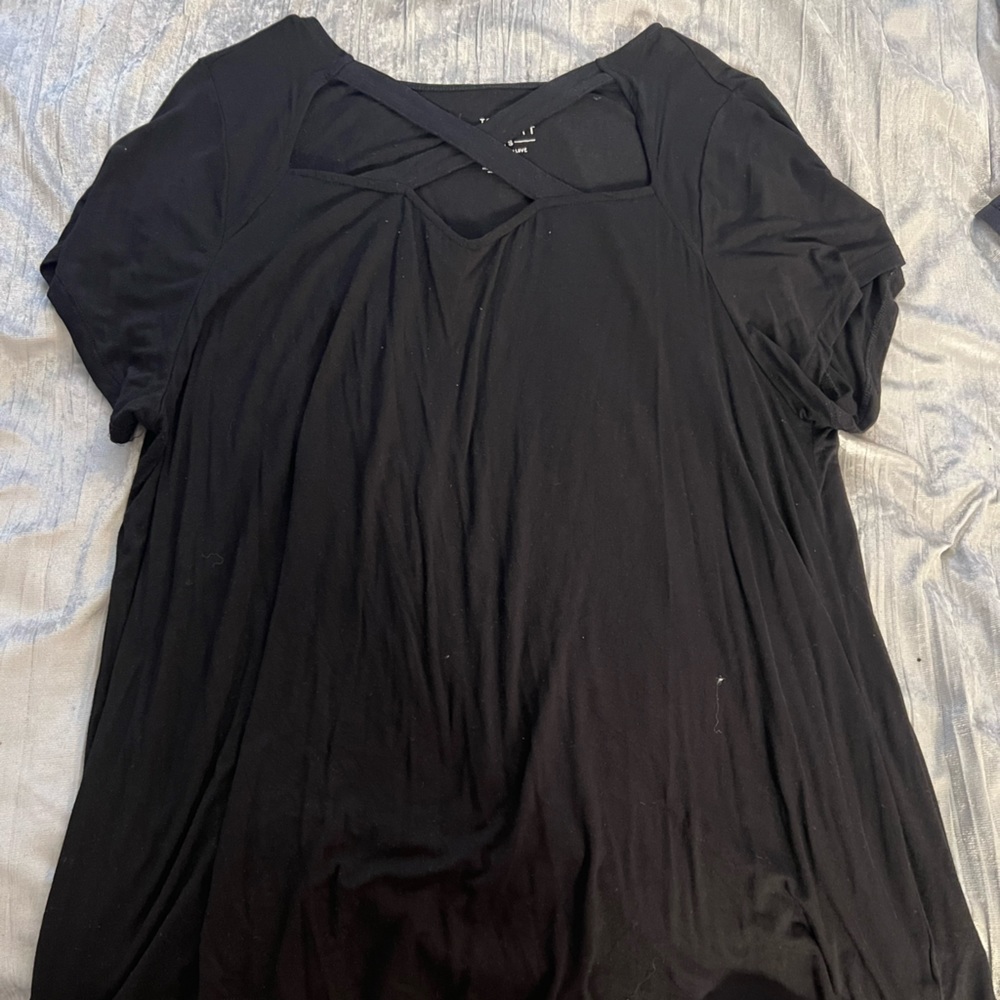 Super soft black torrid top. Short sleeve. Cris gross detail on the chest.